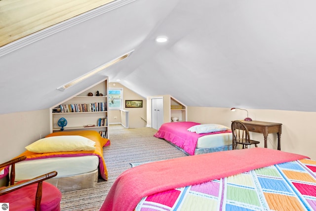carpeted bedroom with lofted ceiling