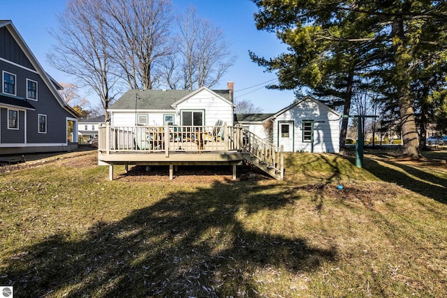 rear view of house with a wooden deck, a lawn, and a chimney