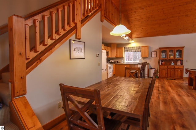 dining room with wood finished floors and stairs