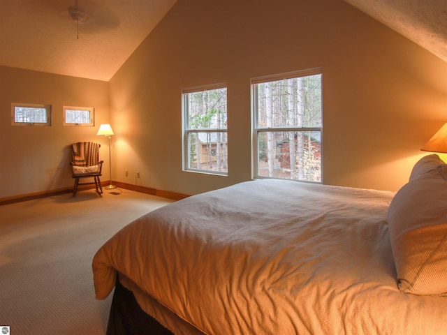 carpeted bedroom with vaulted ceiling and baseboards