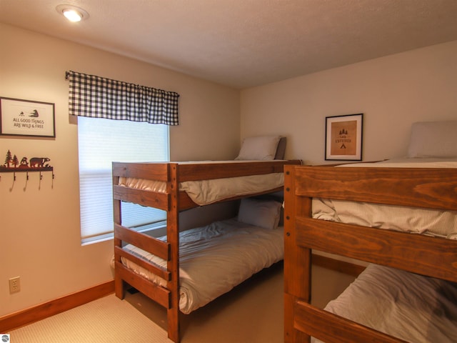 carpeted bedroom with baseboards