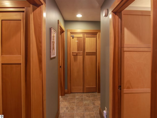 corridor featuring stone finish floor and recessed lighting
