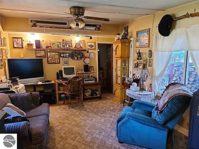 living room featuring ceiling fan and carpet