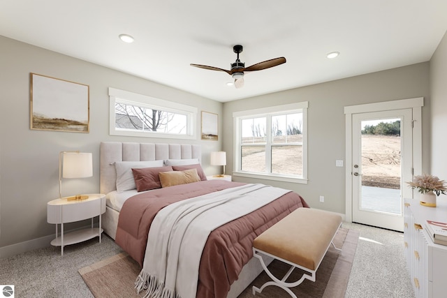 carpeted bedroom featuring a ceiling fan, baseboards, access to outside, and multiple windows