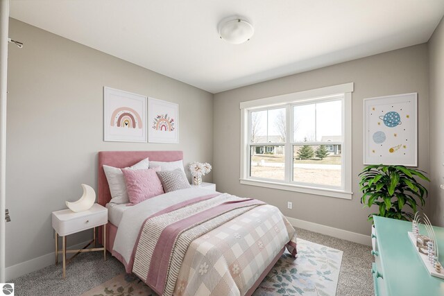 bedroom featuring light carpet and baseboards