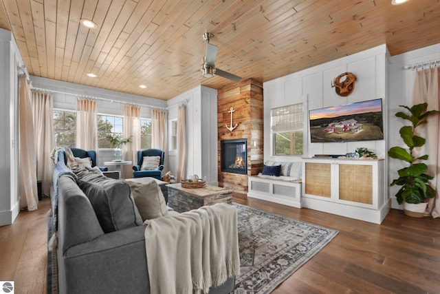 living area featuring a fireplace, plenty of natural light, wooden ceiling, and wood finished floors