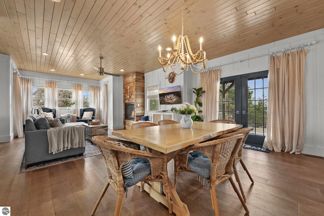 dining room with hardwood / wood-style floors, french doors, a notable chandelier, and wood ceiling