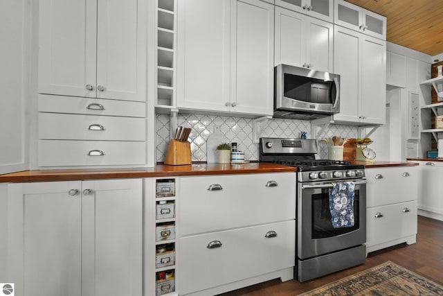 kitchen featuring wooden ceiling, decorative backsplash, stainless steel appliances, and wood counters