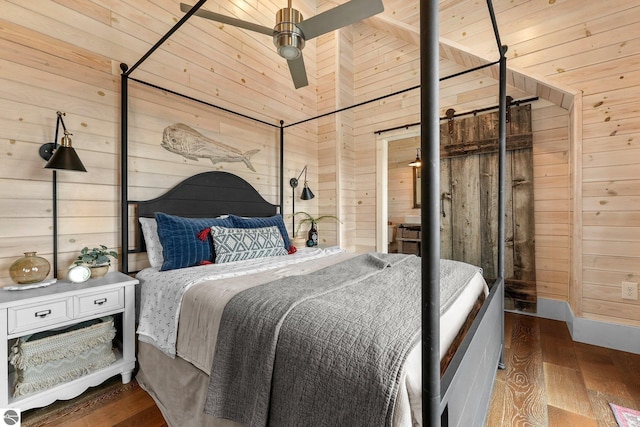 bedroom with wood-type flooring and wooden walls