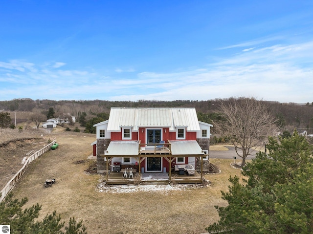 view of front of home featuring metal roof and a deck