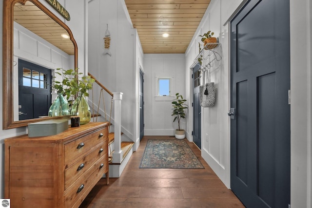 foyer featuring wooden ceiling, stairway, and a healthy amount of sunlight