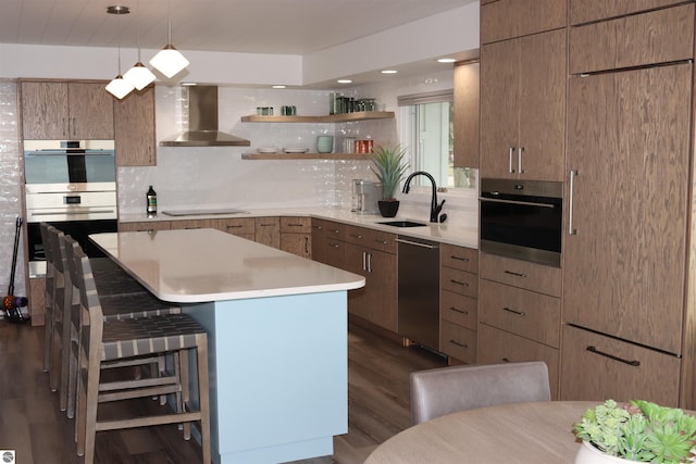 745 S Crescent Ave, Au Gres, MI 48703 - kitchen featuring wall chimney range hood, tasteful backsplash, a sink, dark wood finished floors, and stainless steel appliances