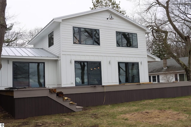 745 S Crescent Ave, Au Gres, MI 48703 - rear view of house with board and batten siding and a yard