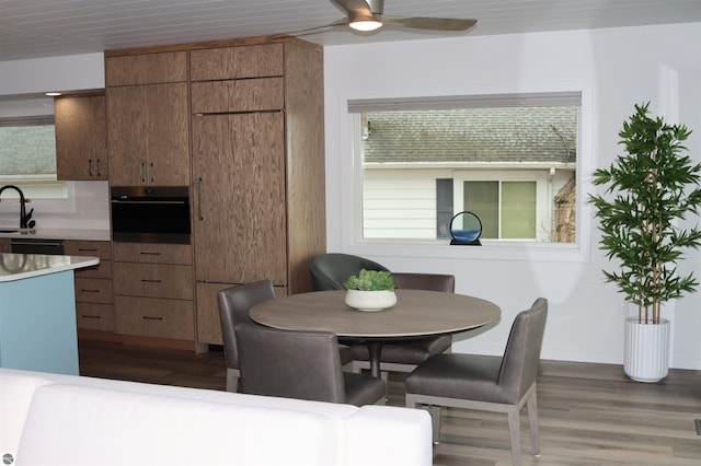 745 S Crescent Ave, Au Gres, MI 48703 - kitchen with brown cabinets, oven, a ceiling fan, and wood finished floors