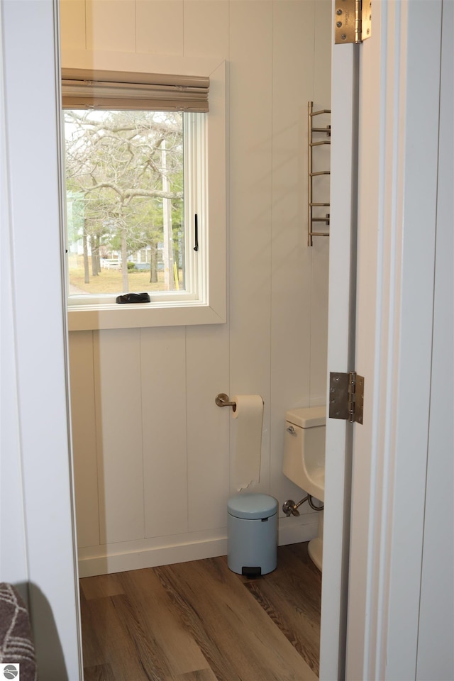 745 S Crescent Ave, Au Gres, MI 48703 - bathroom featuring toilet, wood finished floors, and a decorative wall