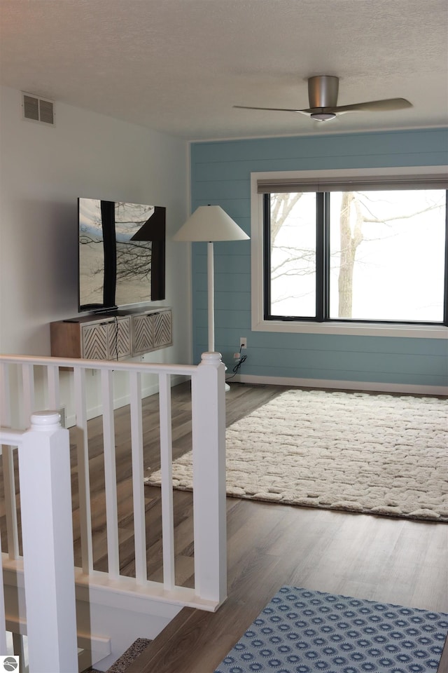 745 S Crescent Ave, Au Gres, MI 48703 - stairway featuring a ceiling fan, visible vents, and wood finished floors