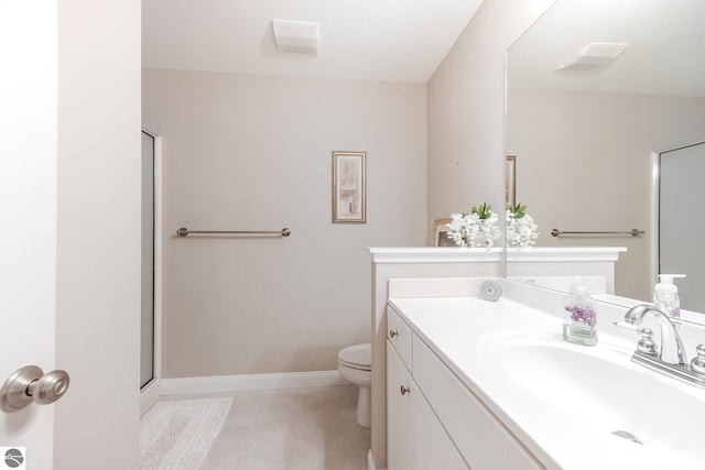bathroom with tile patterned floors, toilet, baseboards, a shower with door, and vanity
