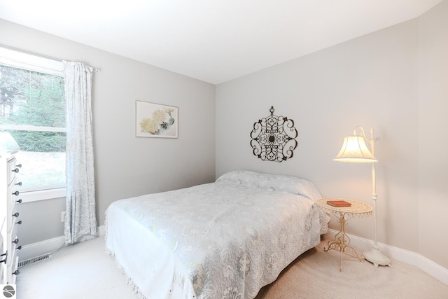 bedroom featuring carpet floors, visible vents, baseboards, and multiple windows