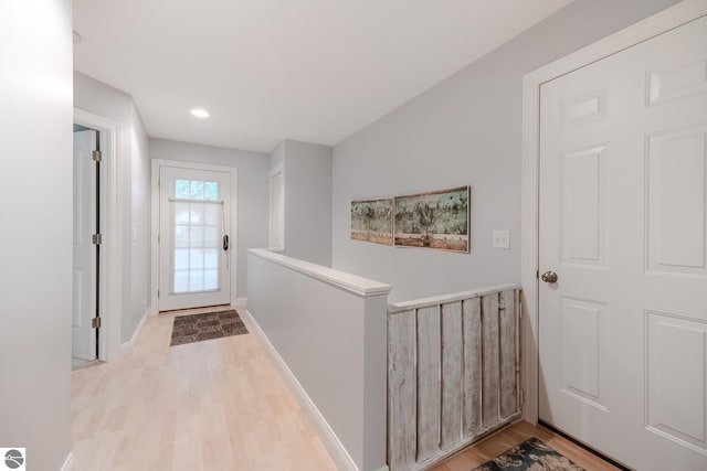 hall with recessed lighting, baseboards, and light wood-type flooring