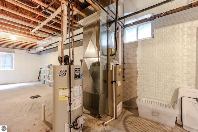 basement featuring brick wall and water heater