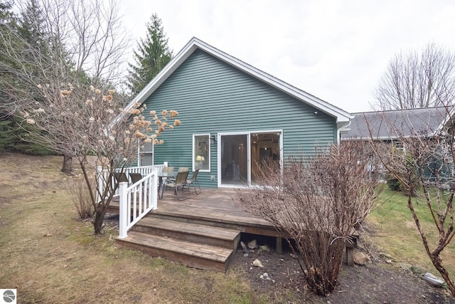 rear view of house featuring a yard and a deck