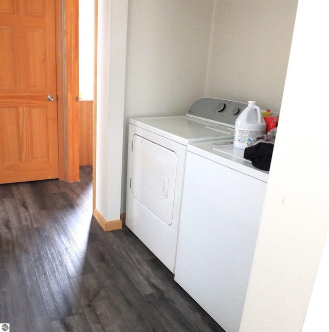 washroom featuring washer and dryer, laundry area, and dark wood-style flooring