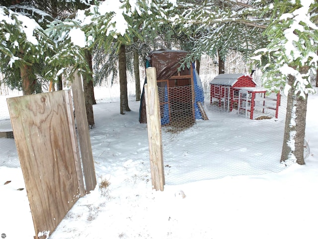 snow covered patio featuring exterior structure and an outdoor structure