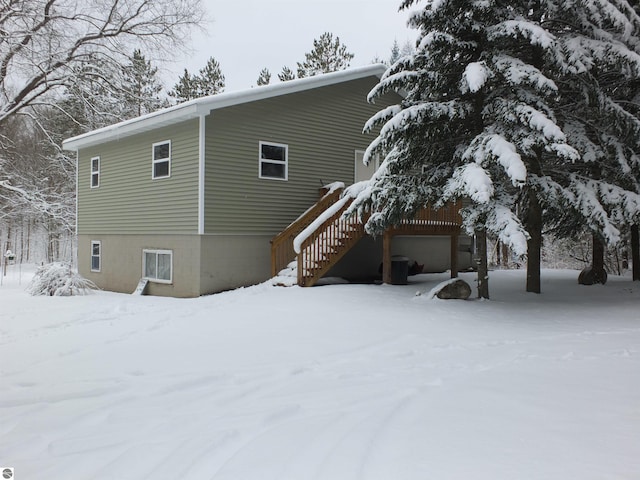 view of snowy exterior featuring stairs
