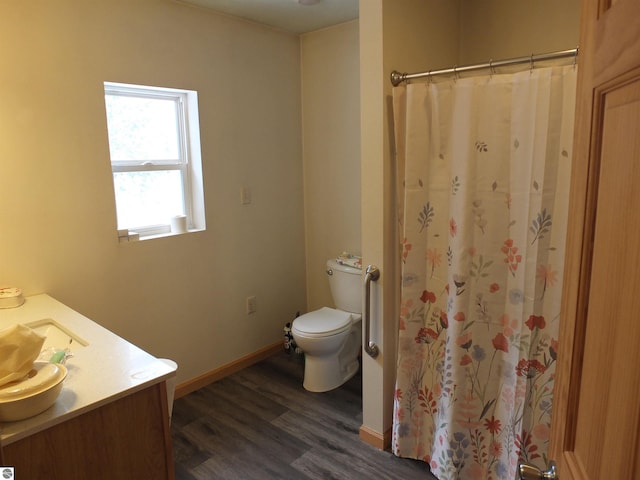 full bathroom with a shower with curtain, toilet, baseboards, wood finished floors, and vanity