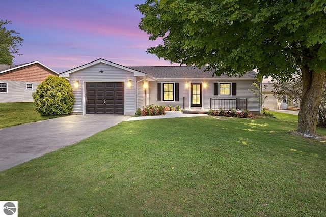 ranch-style home featuring a lawn, an attached garage, and concrete driveway