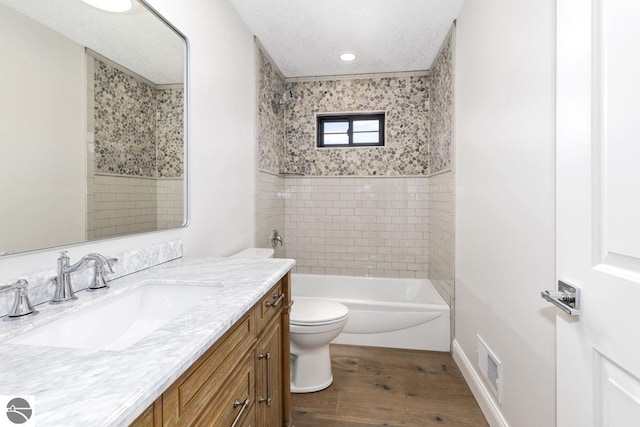 full bathroom with wood finished floors, vanity, shower / washtub combination, toilet, and visible vents