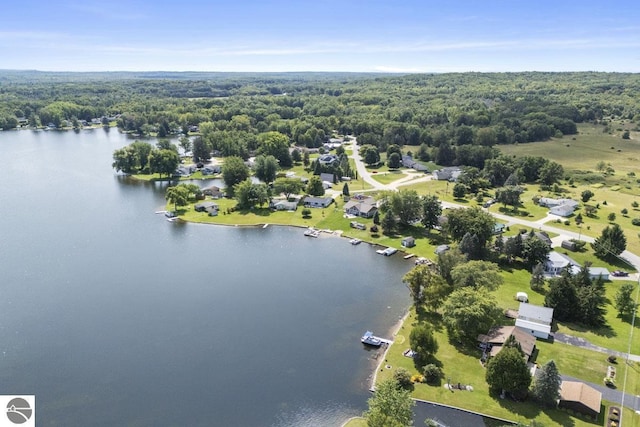 birds eye view of property with a view of trees and a water view