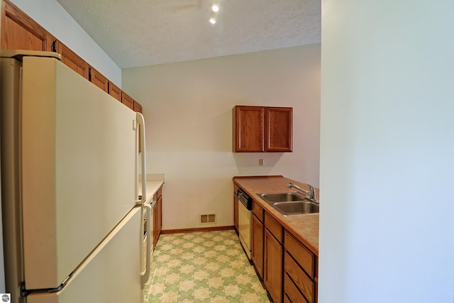 1173 Sunview, Saint Johns, MI 48879 - kitchen with light floors, visible vents, dishwashing machine, a sink, and freestanding refrigerator