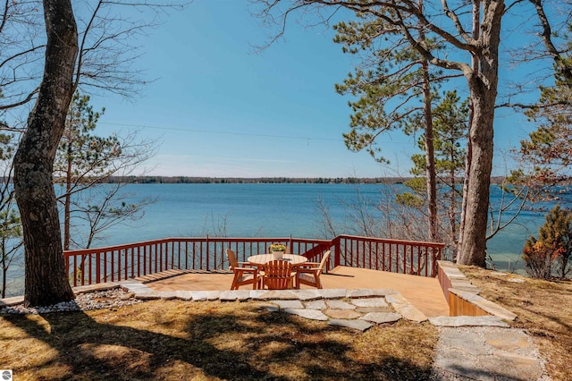 wooden terrace featuring a water view