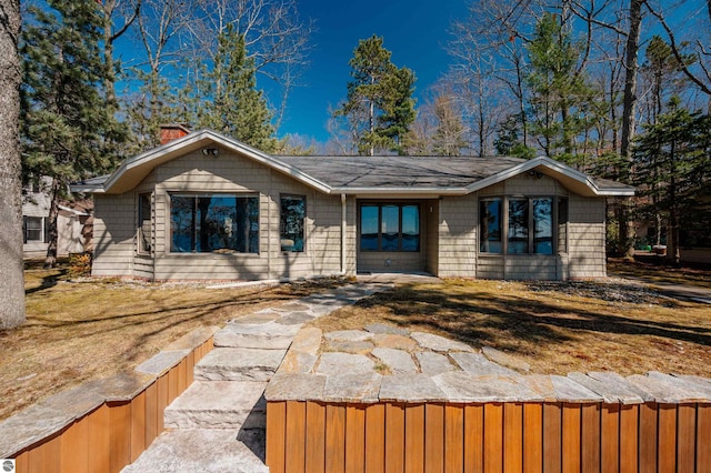 view of front of home featuring a chimney