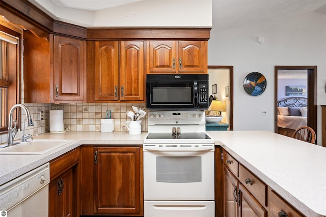 kitchen with backsplash, light countertops, a sink, white appliances, and brown cabinetry
