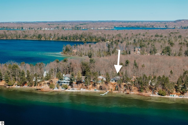 aerial view featuring a wooded view and a water view