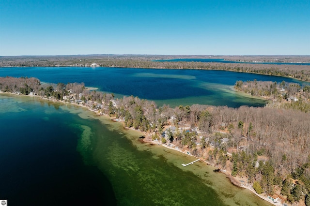 bird's eye view featuring a wooded view and a water view