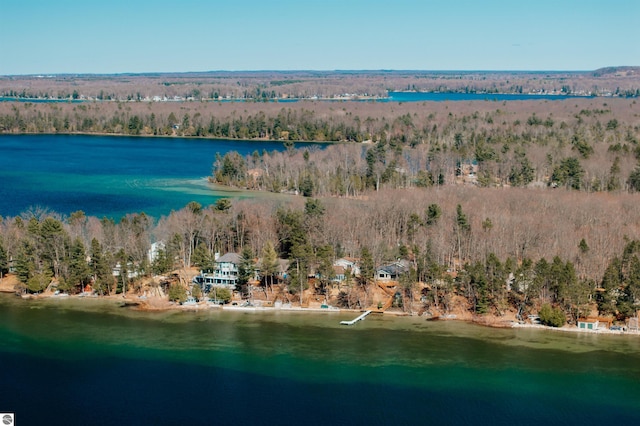birds eye view of property featuring a wooded view and a water view