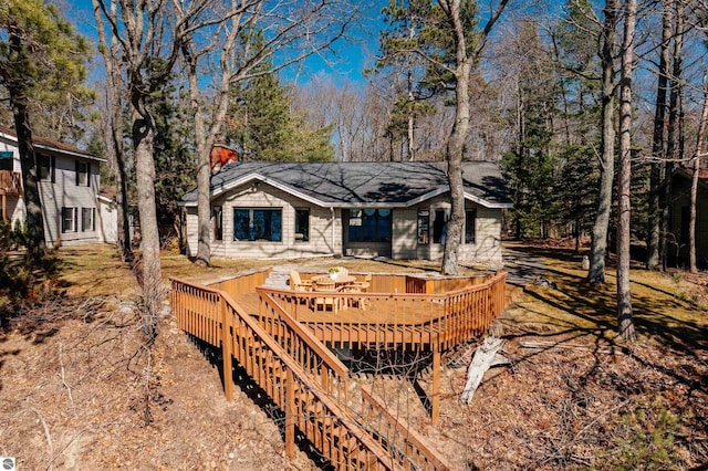 exterior space featuring a wooden deck and a chimney