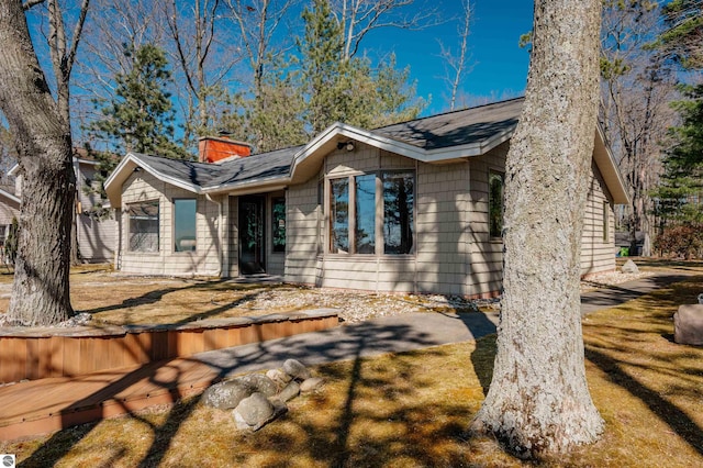 ranch-style home with a chimney