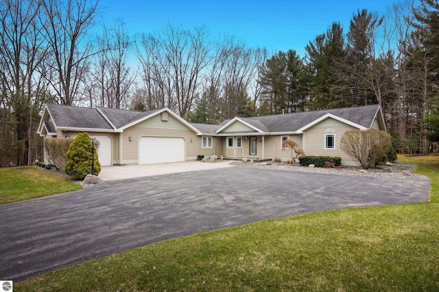 ranch-style home with an attached garage, a shingled roof, driveway, and a front yard