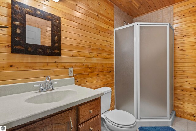 bathroom with wooden walls, vanity, tile patterned flooring, and a shower stall