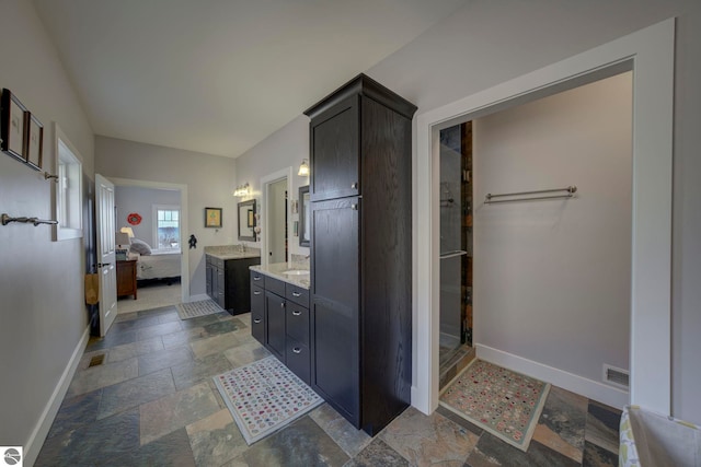 full bathroom featuring a shower stall, visible vents, vanity, ensuite bath, and baseboards