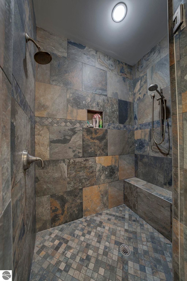 bathroom with tiled shower