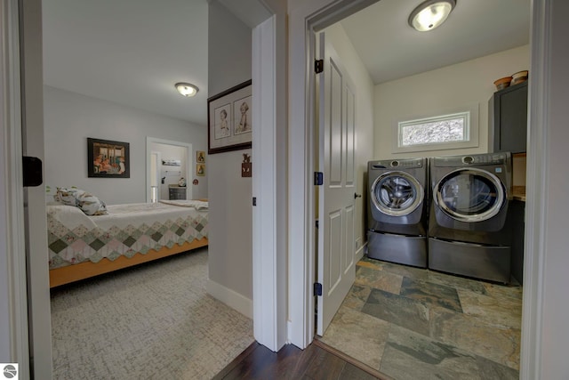 laundry room featuring baseboards, independent washer and dryer, and laundry area