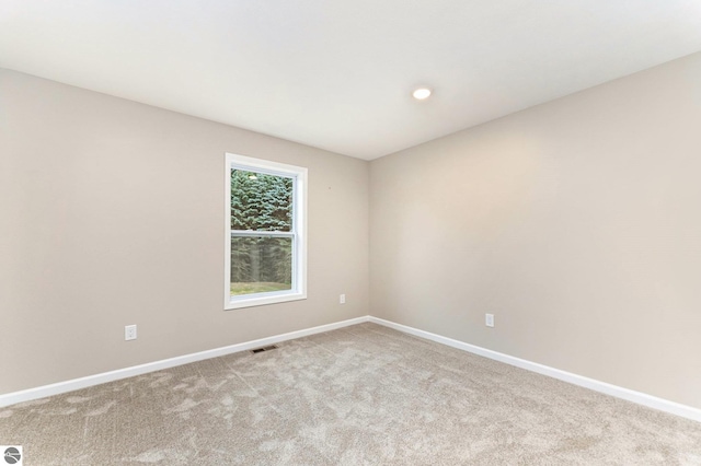 empty room featuring baseboards, carpet flooring, visible vents, and recessed lighting