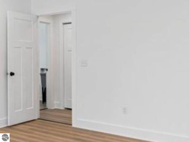 interior space featuring baseboards and light wood-style floors