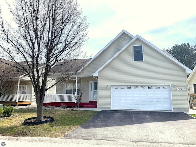 2708 Ruby St, Traverse City, MI 49684 - view of front of property with driveway, a porch, and a front yard