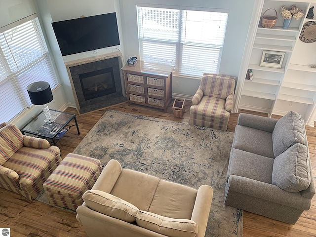 2708 Ruby St, Traverse City, MI 49684 - living room with wood finished floors, baseboards, a fireplace with flush hearth, and built in shelves